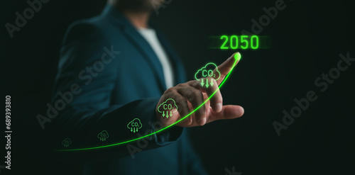 Businessman point to increasing arrow with carbon reduction for decrease CO2, carbon footprint and carbon credit to limit global warming from climate change, Bio Circular Green Economy concept.