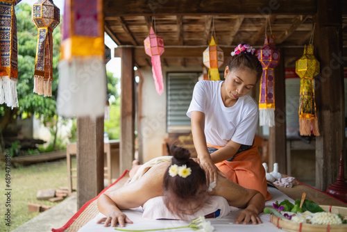 Massage and spa relaxing treatment of office syndrome traditional thai massage style. Asain female masseuse doing massage and skin scrub treat back pain, arm pain and stress for good skin and health.