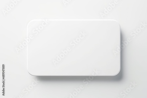top view of white badge float on white background. Glossy round button.