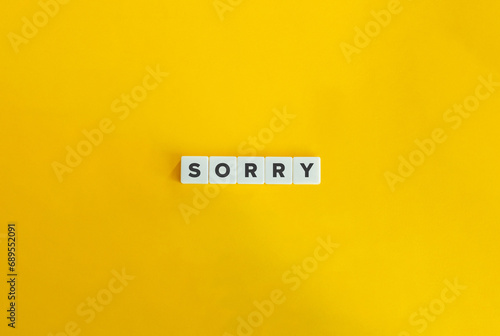 Sorry Word on Block Letter Tiles on Yellow Background. Minimalist Aesthetics.