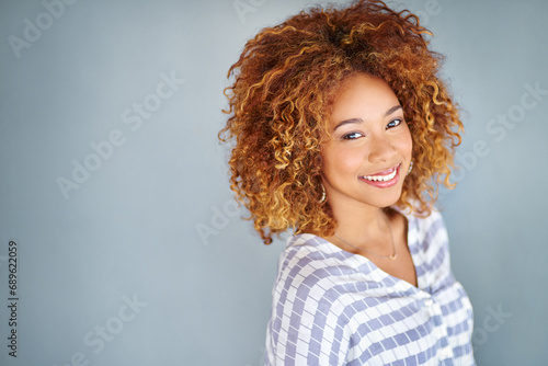 Portrait, happy and creative business woman isolated on a gray background mockup space. Face, professional smile and designer employee, female entrepreneur or young worker at startup in South Africa