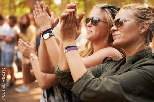 Hands, applause and woman friends at a music festival outdoor for a concert, party or event of celebration. Audience, crowd or young people at a carnival together for performance or entertainment