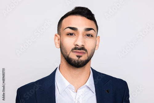 Portrait of serious concentrated in bad mood turkish man in studio isolated over grey background looking at camera smiling with white teeth buisneesman young successful guy.