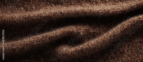 Background is made of woolen textiles An image of fleecy speckled tweed fabric Brown woolen fabric with large weave. Copyspace image. Square banner. Header for website template