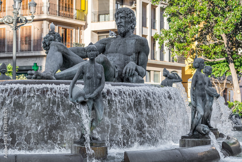 Valencia, Spain -September 22th, 2023: La Fuente del Turía, fountain and statues commemorating the Turia river, Plaza de la Virgen, Neptune statue.