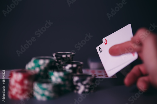 Dealer or croupier shuffles poker cards in a casino on the background of a table, chips. Concept of poker game, game business. Playing for money, a big win, a jackpot, gambling, a desire to get rich. 