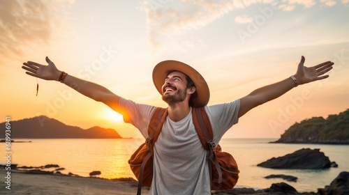 A Happy male traveler in hat and backpack raising arms on beach at sunset Delightful male traveler enjoying quiet time, travel and mental health.