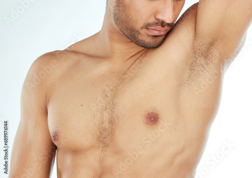 Body, closeup and man smelling armpit in studio for wellness, hygiene or control on white background. Underarm, care or guy model with sweat, scent or odor check after shower, cleaning or grooming