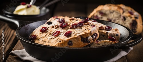 St. Patrick's Day recipe idea: Irish soda bread cooked in a cast iron pan with cranberries, pecans, and served with Irish butter.