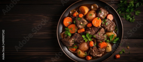 Top view of beef stew with carrots.