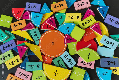 back to school background. colorful math fractions and notebook on the table. Mathematics and geometry in preschool and school