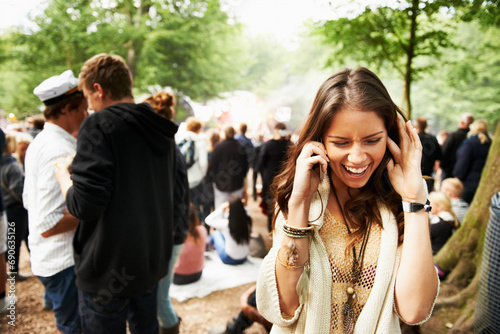 Woman, phone call and loud music festival for communication, conversation or networking in nature. Female person struggling to hear on mobile smartphone for discussion at outdoor concert or event