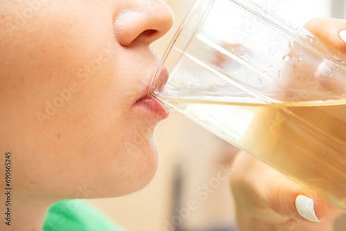 Closeup of woman drinking juice from glass
