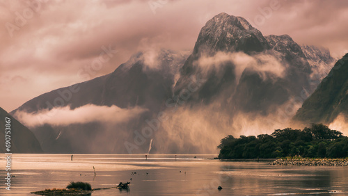 Photograph looking into Milford Sound on a cloudy and rainy day from the boat harbour in Fiordland National Park on the South Island of New Zealand