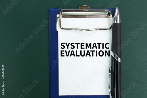 pen and paper board with the word systematic evaluation. the concept of systematic evaluation