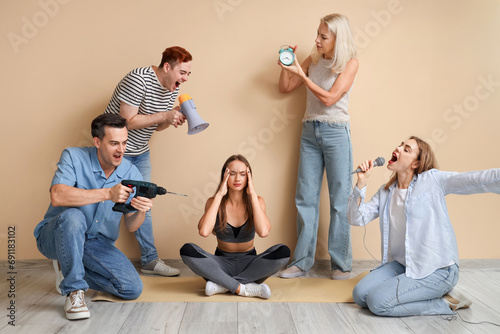 Sporty young woman suffering from loud neighbours at home