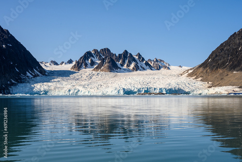 Beautiful view and reflection of the Monacobreen Glacier in Liefde Fjord, Svalbard, global warming showing in the melting ice 