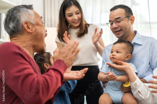 Portrait of happy love family asian father and mother playing with adorable asian baby and sister girl.newborn, infant.mom touching with cute son moments good time with grandparents.Love of big family