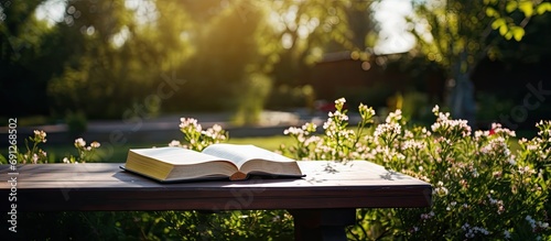 Bible on table in garden.