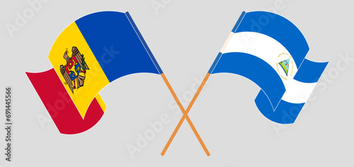 Crossed and waving flags of Moldova and Nicaragua