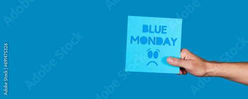 man with a sign with the text blue monday, banner