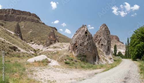 panaroma view of the eroded volcainc landscape with dirt road leading to Soğanlı Valley, Cappadocia, Turkey