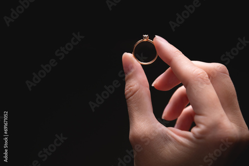 ring is held with the fingers, demonstrating the diameter of the ring and its type. jewelry in a woman's hand