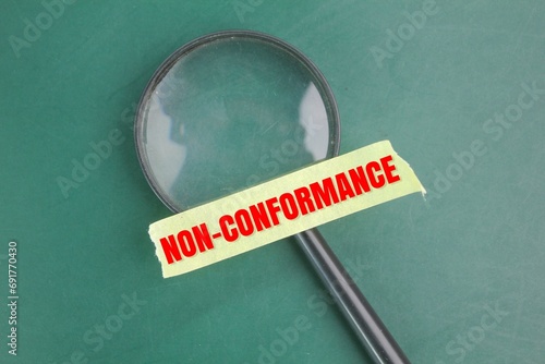 magnifying glass and selotape with the word non-conformance