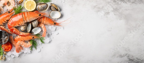 Seafood medley displayed on a white platter on a concrete table, viewed from above, with empty space around it.
