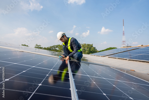 Engineer service check installation solar cell on the roof of factory. Silhouette technician inspection and repair solar cell on the roof of factory. Technology solar energy renewable.
