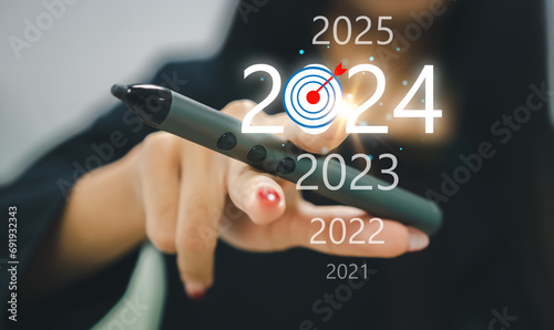 Human touching on 2024 new year wording for marketing and business planing, action plan for success growth, trend on 2024 and new ideas, startup, technology, new business plan and development