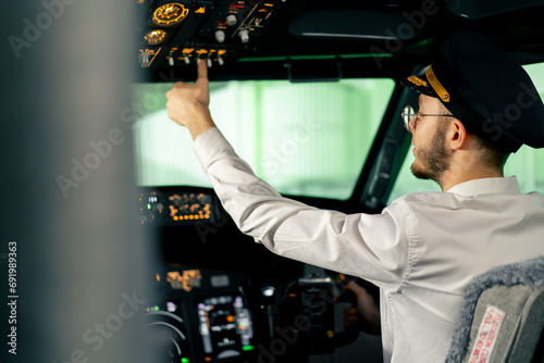 Airplane cabin The pilot checks the plane's electronics by pressing the buttons Preparing the passenger liner for takeoff