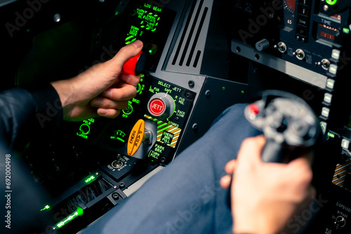 close-up of the cockpit of a military plane a pilot with a steering wheel and many buttons on the control panel of an airplane flight simulator