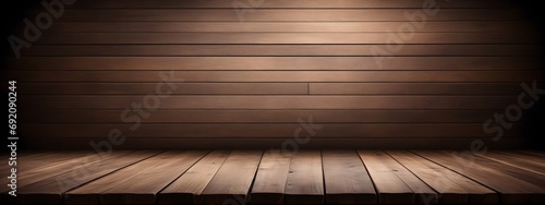 An old wooden table against the background of a dark brown room made of boards. Wood background for advertisement and design.