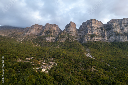 Drone scenery mikro Papingo village , Zagorochoria area, Epirus, Ioannina Greece. Astraka tower rocky cliffs above the village at sunset