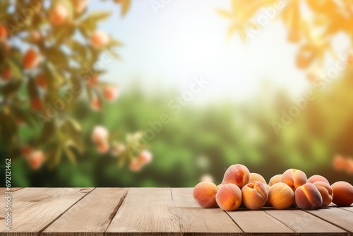 Wooden table top with apricots on blur background with apricot orchard