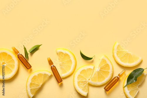 Ampoules with vitamin C and lemon slices on yellow background