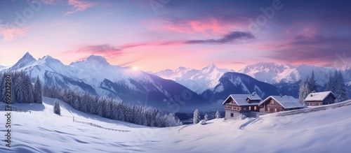 Beautiful view of snow covered houses in village Majestic mountain range against cloudy sky during sunset Holiday homes in alpine region during winter. Copy space image