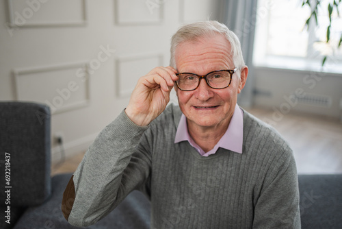 Portrait of confident stylish European middle aged senior man at home. Older mature 70s man smiling. Happy attractive senior grandfather looking camera close up face headshot portrait. Happy people