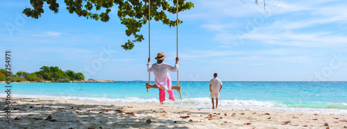 A couple of men and women at a swing on the beach of Koh Samet Island Rayong Thailand, a couple on honeymoon in Thailand