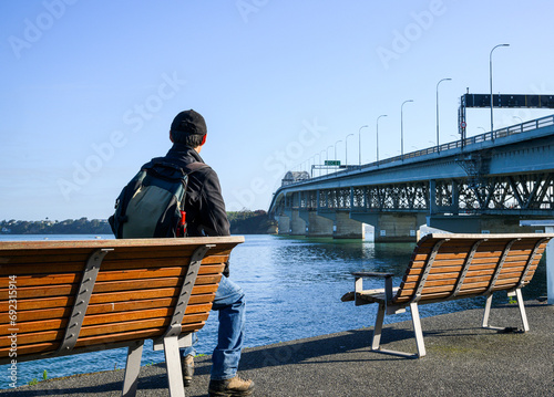 Tourist enjoying the view of Auckland Harbour Bridge.