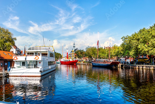 Harbor of Emden city with historic light vessel and sailship, Lower Saxony, Germany