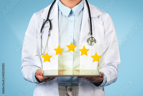 Doctor showing 5-star review on tablet