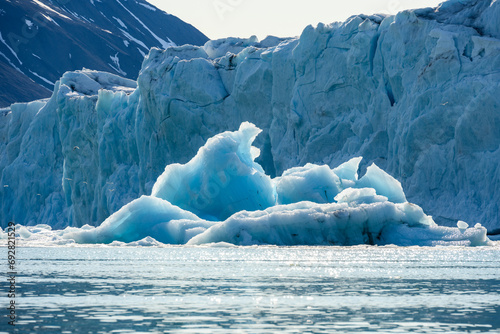 Recently calved from the Monacobreen Glacier in Liefde Fjord, iceberg floating in the arctic ocean around Svalbard, signs of climate change and global warming 