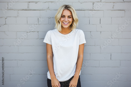 Portrait of a smiling young woman standing against a white brick wall