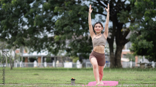 Young Asian woman exercise Do yoga in the park to improve your health.