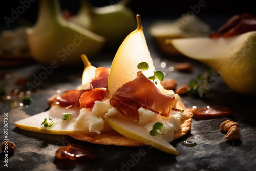 Delicious canapes with pear, goat cheese, and pancetta crisps on the plate close up