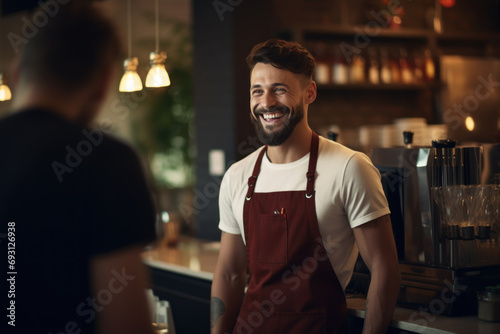 A happy young barista is talking and giving advice about drinking coffee at a coffee shop.
