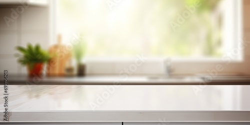 Blurred white modern kitchen background with empty corner countertop or table.