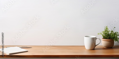 Front view of a workspace with a white desk table, copy space, supplies, and a coffee mug.